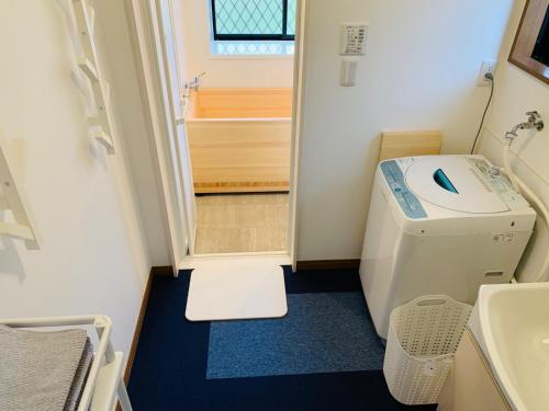 a small bathroom with a toilet and a sink at Sunhouse - Vacation STAY 28595v in Yachimata