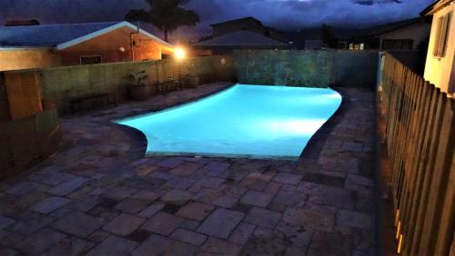 a swimming pool in a backyard at night at Ti case reunion 400 in Saint-Pierre