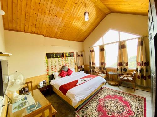 a bedroom with a bed and a large window at Sai Cottage Shimla in Shimla