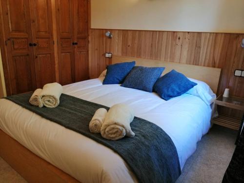 a bedroom with a large bed with towels on it at Encant Rural a Cal Japet in Fonollosa