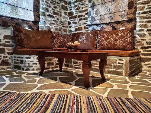 a living room with a couch and a table at KERAMIDI GUESTHOUSE in Keramídhion