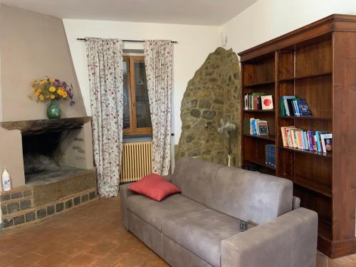 a living room with a couch and a fireplace at La Maremmana in Talamone