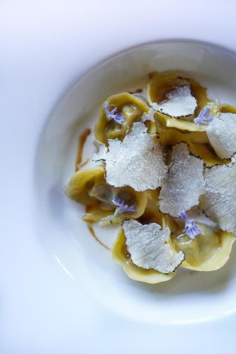 a white bowl filled with food on a table at Il Borro Relais & Châteaux in San Giustino Valdarno