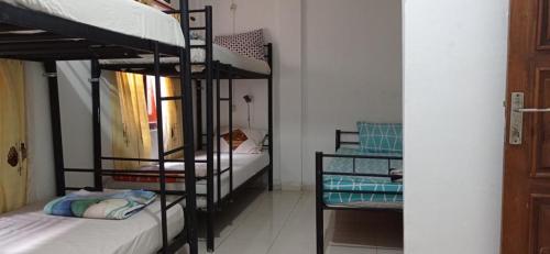 a room with two bunk beds in a room at Laura's Backpacker 523 in Yogyakarta