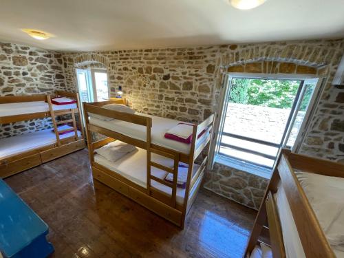 a room with two bunk beds and a window at Tequila Bar Hostel in Zadar