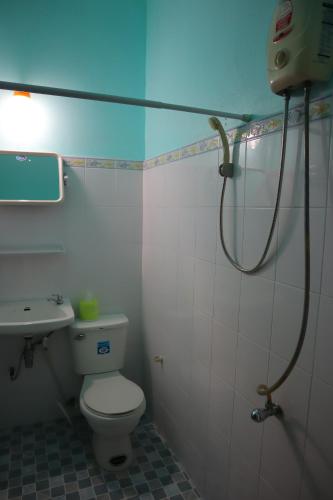 a bathroom with a toilet and a sink and a shower at Ban Sulada Guest House in Laem Ngop