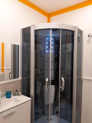 a shower with a glass door in a bathroom at Politeama Center in Palermo