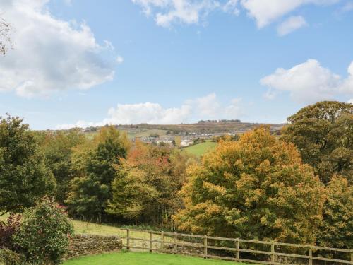 a view from the top of a hill with trees at Bronte Barn in Keighley