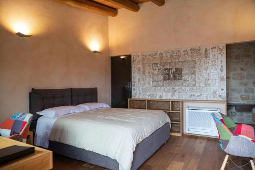 a bedroom with a bed and two chairs and a fireplace at DONNAPAOLA MODERN FARM in Altamura