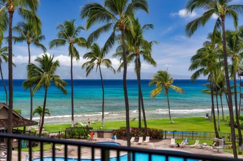 a view of the beach from the balcony of a resort at Papakea K406 OceanView 2 Bedroom 2 bath condo in Kahana