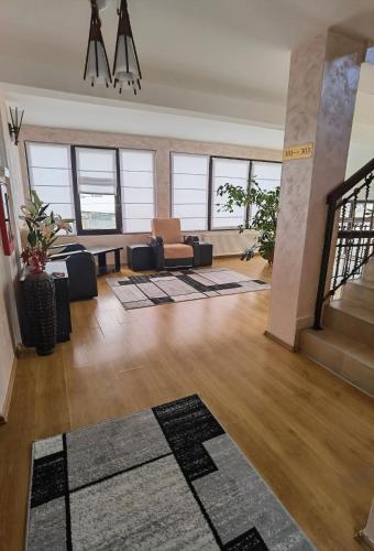 a living room with a couch and a table at Pensiunea Royal in Borşa