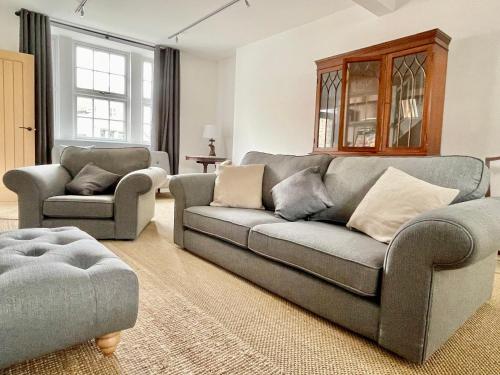 a living room with a couch and two chairs at The Old Post Office - central Helmsley with parking in Helmsley