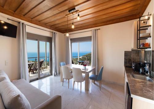 een keuken en een woonkamer met een tafel en stoelen bij MELIKIRON LUXURY APARTMENTS in Ayios Nikitas