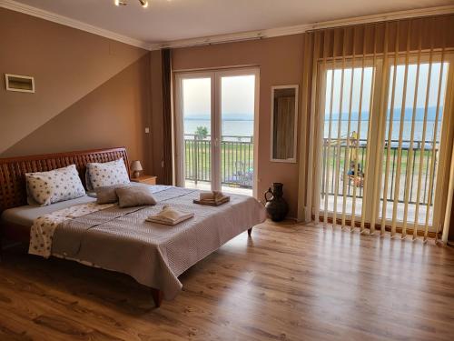 a bedroom with a bed with a view of the ocean at Sun and river Apartments in Golubac