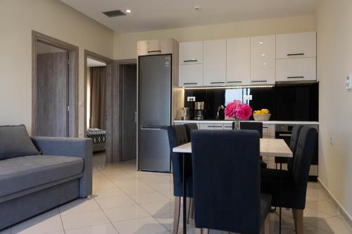 a kitchen and living room with a table and a couch at Gramvoussa Bay in Kissamos