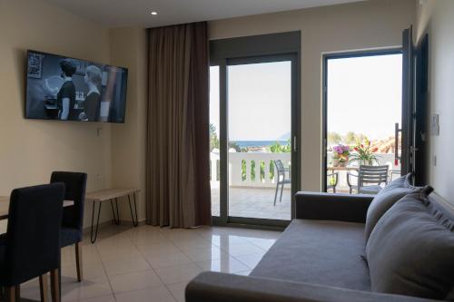 a living room with a couch and a sliding glass door at Gramvoussa Bay in Kissamos