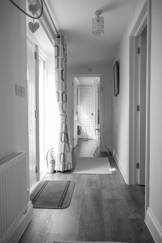 a room with a hallway with a curtain and a door at The Stables in Halesworth