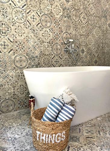 a bathroom with a basket of towels next to a tub at Casa di Campara in Neum