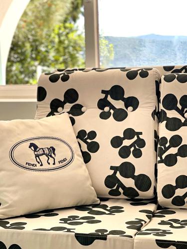 a couch with black and white pillows on it at Casa di Campara in Neum
