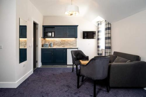 a living room with a couch and a table at Bridge Inn Studio Apartments in Donegal