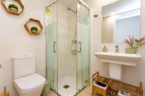 a bathroom with a toilet and a sink and a shower at Denia Apartment Marina Real in Denia