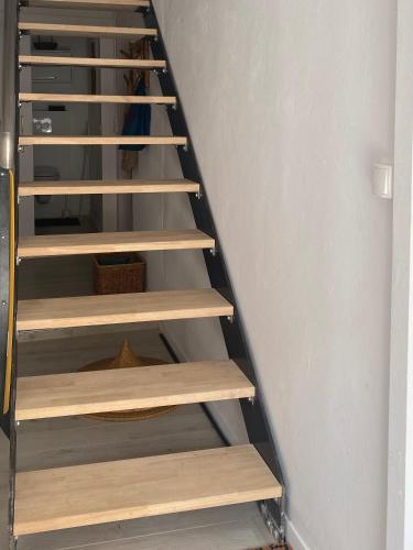 a staircase with wooden shelves in a room at Lou Mut in Lectoure