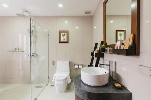 a bathroom with a toilet and a sink and a shower at El Barrio Lanna in Chiang Mai