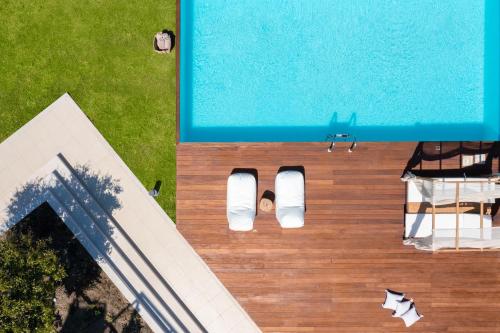 an overhead view of a swimming pool next to a house at Love White Villa in Ialysos
