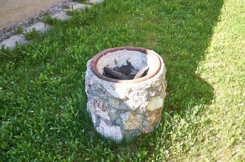 a stone planter sitting in the grass at Apartmany pod Tatrami in Važec