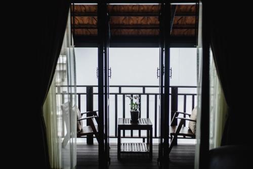 a view of a balcony with a table and chairs at El Barrio Lanna in Chiang Mai