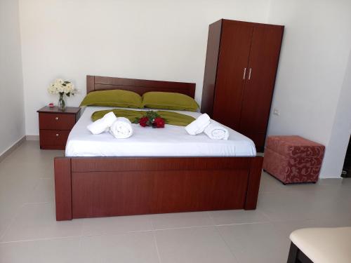 a bedroom with a large bed with towels on it at Emiljano Seaview in Ksamil