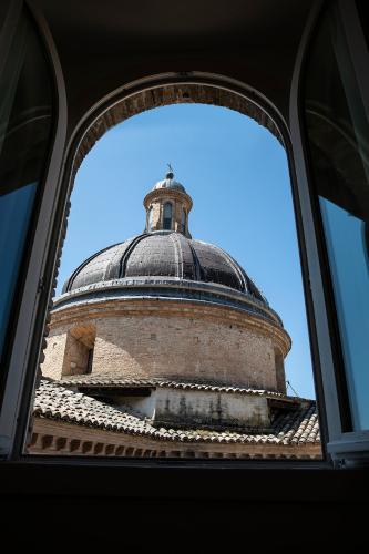 a view of a building through a window at Asisium Boutique Hotel in Assisi