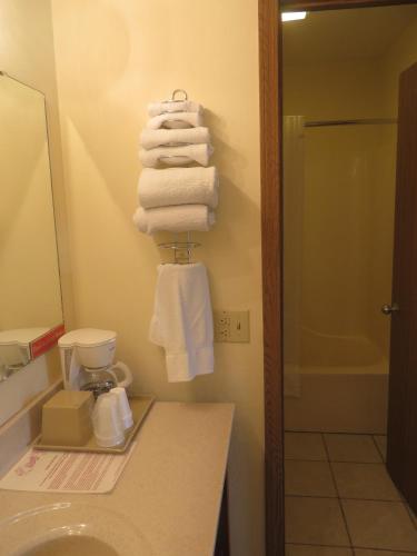 a bathroom with a pile of towels on a wall at Honeysuckle Inn in Mountain View