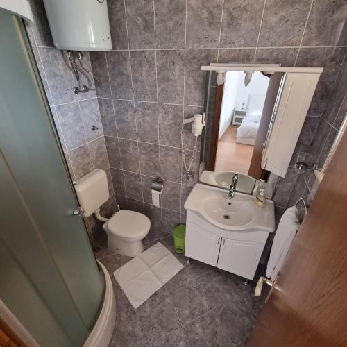 a small bathroom with a toilet and a sink at Villa Mila in Bol