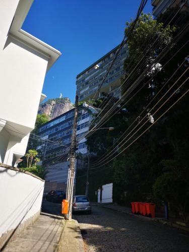 a building with a car parked on the side of a street at Encanto da Lagoa in Rio de Janeiro