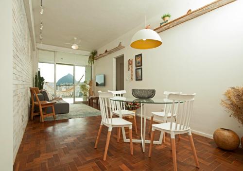 a dining room with a glass table and chairs at Encanto da Lagoa in Rio de Janeiro