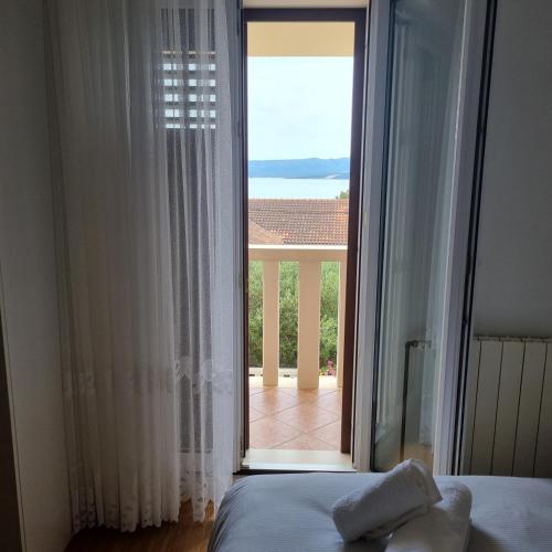 a bedroom with a large glass door to a balcony at Villa Mila in Bol