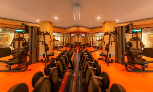 a gym with a row of treadmills and machines at Samara Hotel Bodrum Ultra All Inclusive in Torba