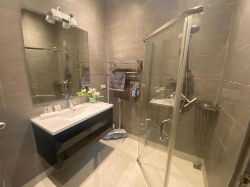 a bathroom with a sink and a shower at Relax and Rejuvenate in Rayong! in Rayong