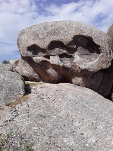 a large rock sitting on top of some rocks at Spring Family Guest House in Tersak
