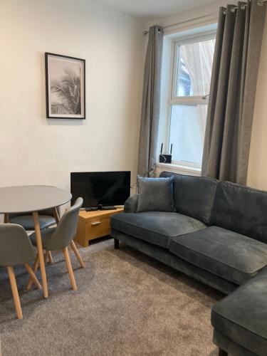 a living room with a couch and a table at Halfway House in Goole