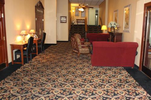 a living room with a red couch and a table at Quality Inn Shenandoah Valley in New Market