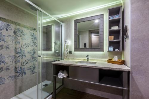 a bathroom with a sink and a shower at Samara Hotel Bodrum Ultra All Inclusive in Torba