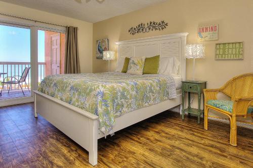 a bedroom with a bed and a balcony at Beach Cottage 2402 in Clearwater Beach