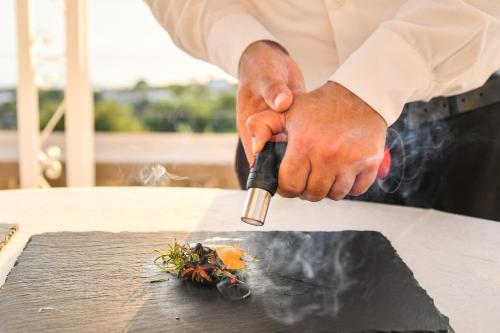 a chef preparing food on a table with a knife at Tenuta C'est la Vie in Ischia