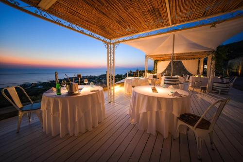a marquee with tables and chairs on a deck at Tenuta C'est la Vie in Ischia