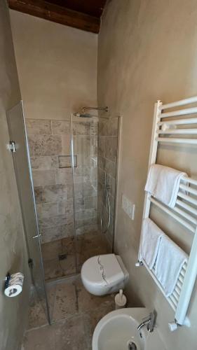 a bathroom with a shower and a toilet and a sink at Antico Mondo Rooms & Suites in Polignano a Mare