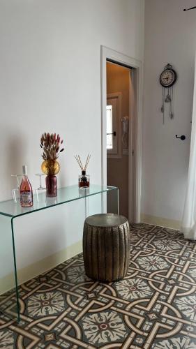 a room with a glass table and a barrel stool at Antico Mondo Rooms & Suites in Polignano a Mare