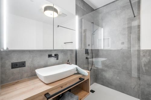 a bathroom with a white sink and a shower at Mountain Moments in Sautens