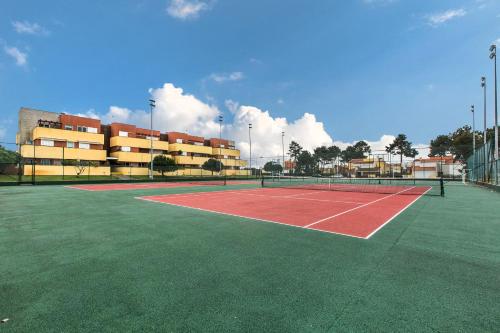 a tennis court in front of a building at Furadouro Beach and Club Apartment in Ovar